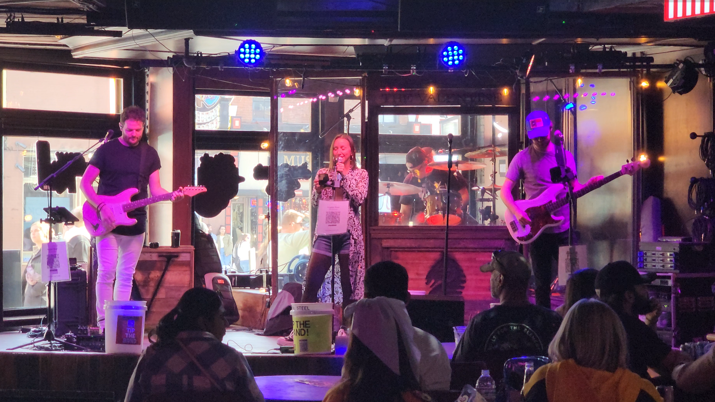 A full band performs on a Broadway stage in Nashville.